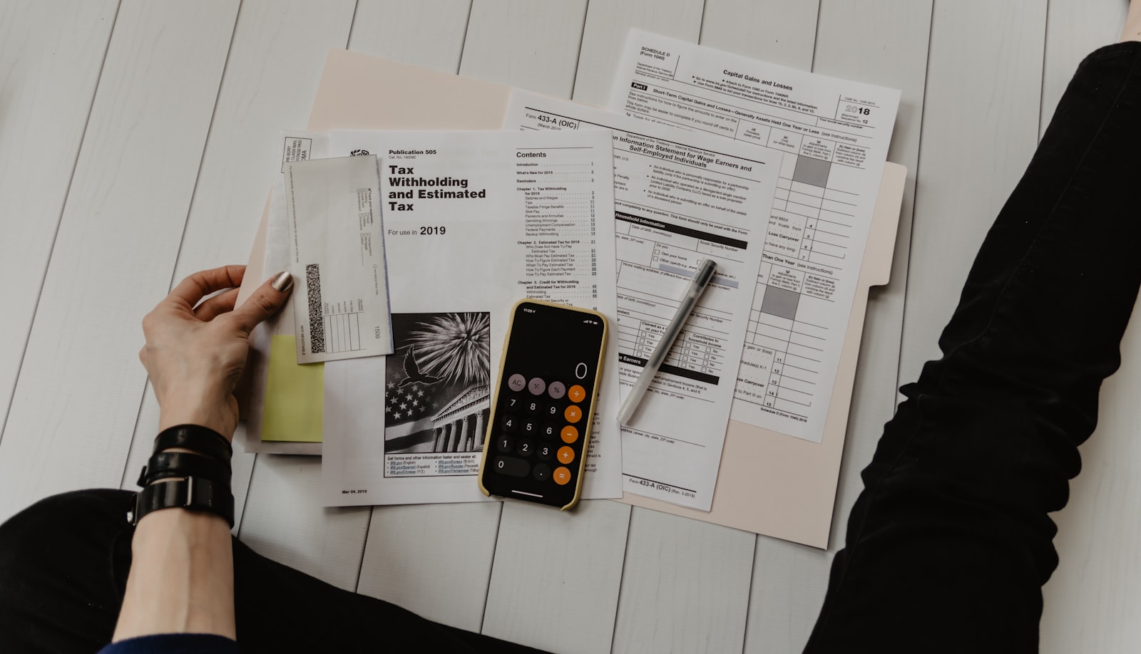 Desk with calculator and tax documents, preparing a Germany tax refund
